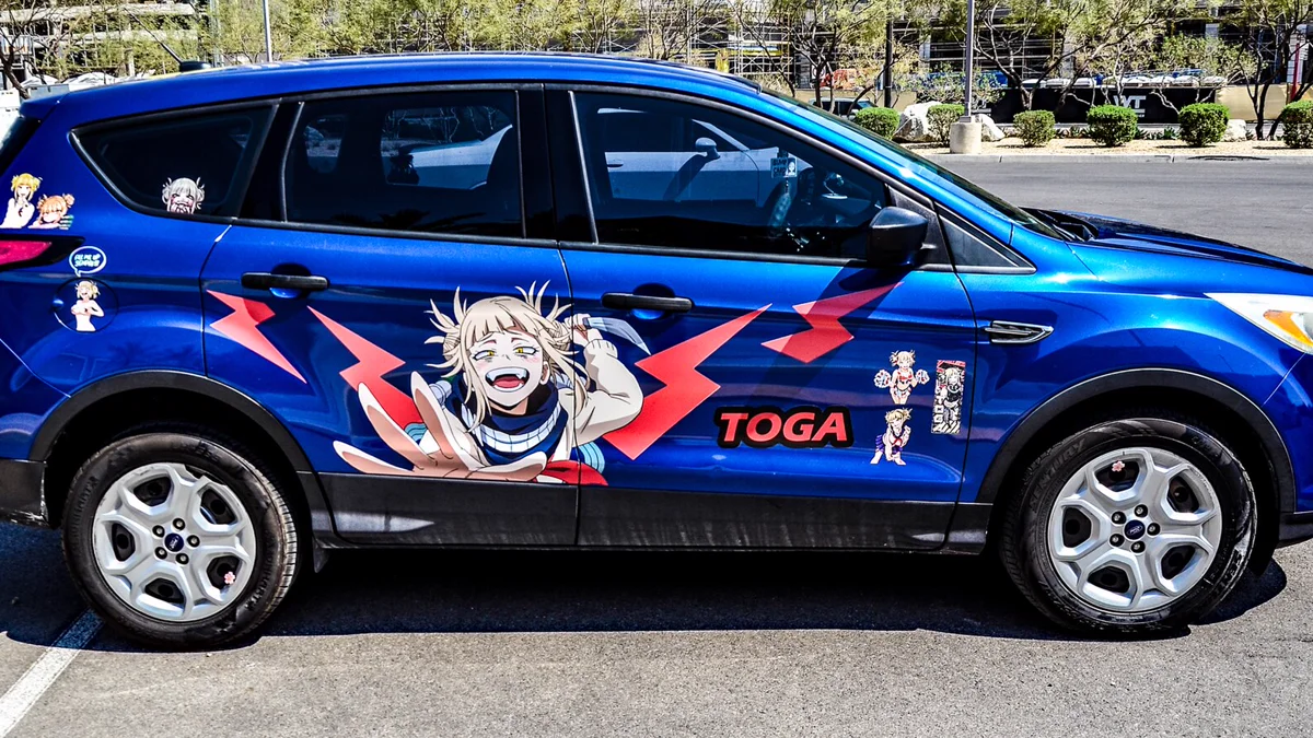 Character peeker decals and anime styling graphics on automotive glass Vehicle rear passenger window displaying anime car decal placement