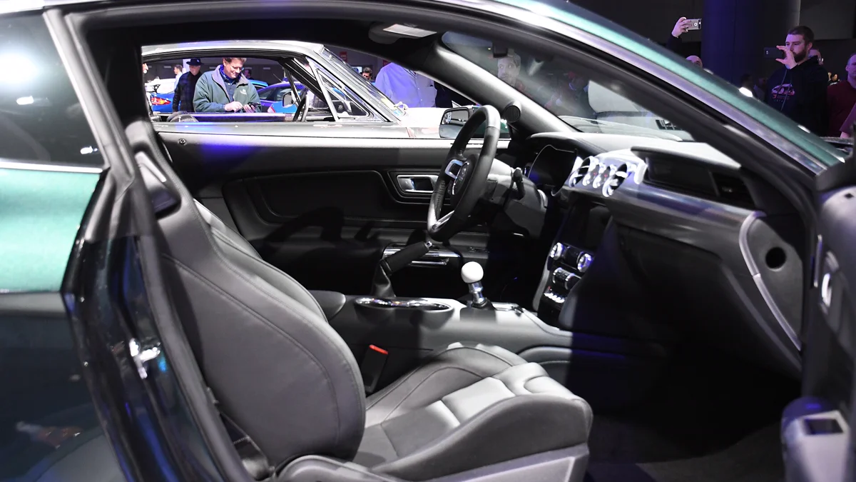 Front seat and center console area displaying customized upholstery and white shifter knob