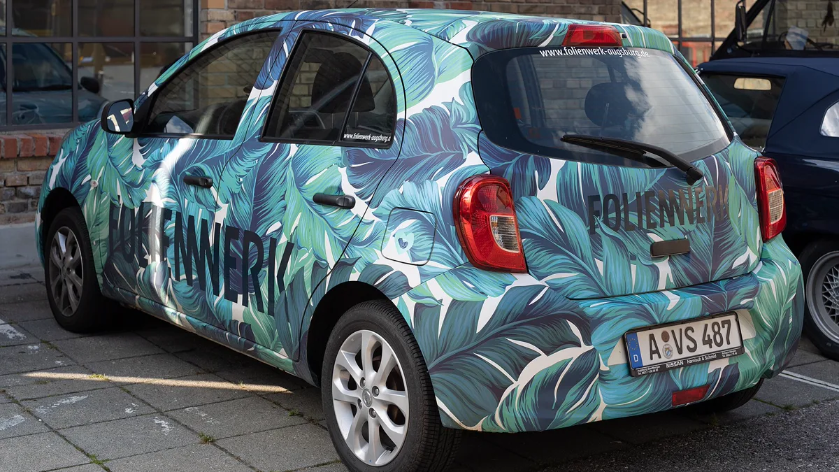 Geometric pattern vinyl wrap on car exterior demonstrating full coverage custom graphics