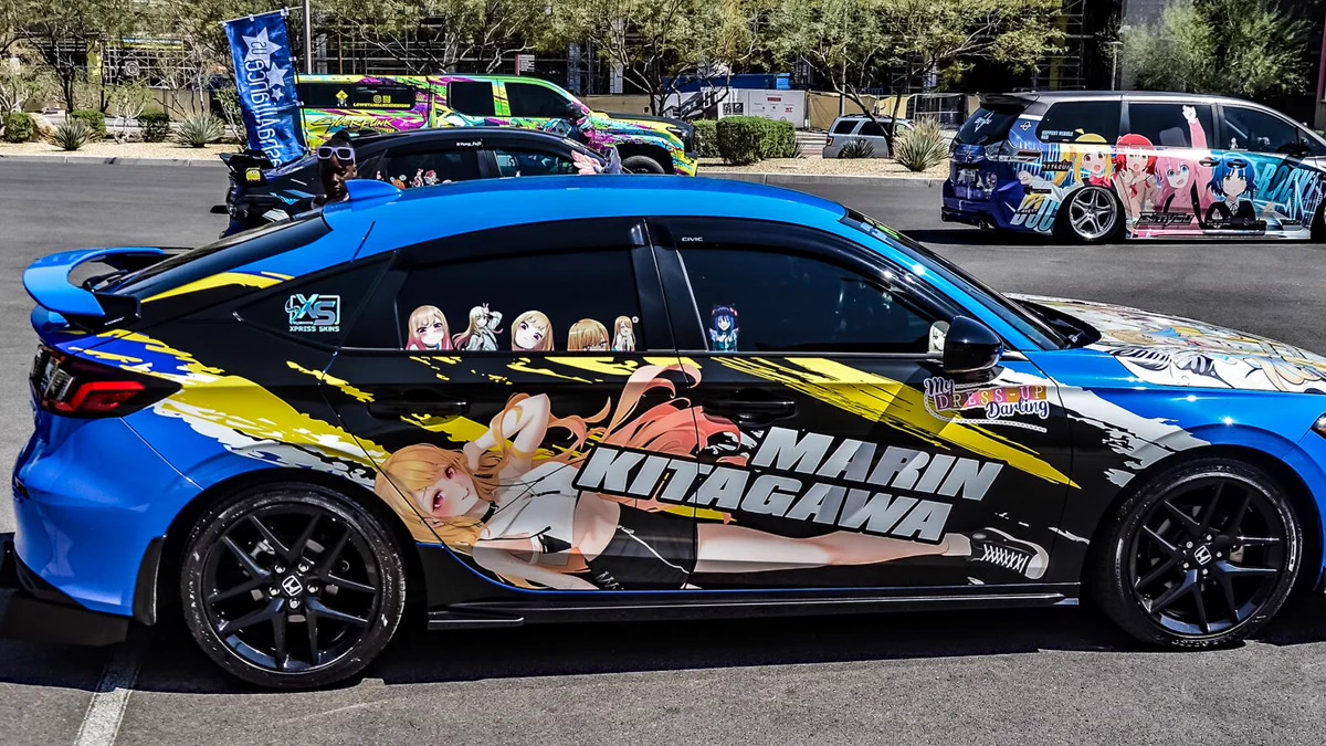 Multi-character die-cut anime car decals along vehicle rocker panel Close view of die-cut vinyl anime character decals installed on car door
