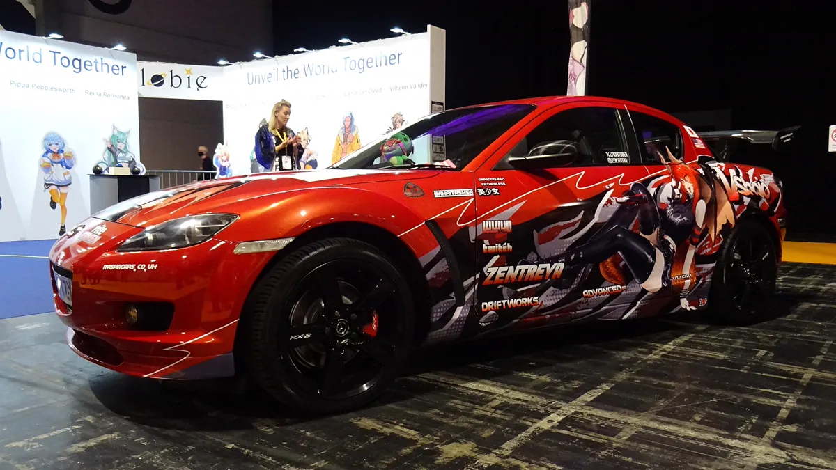 Side profile view of vehicle showing partial anime car wrap door graphics