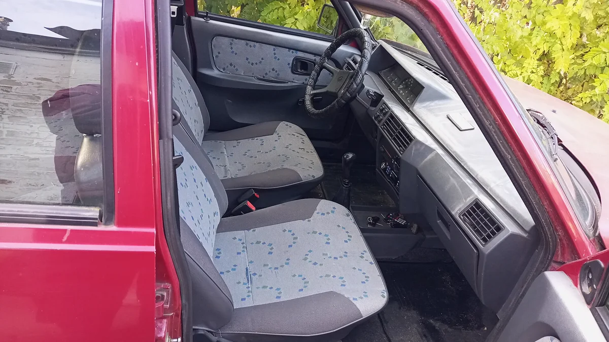 Front passenger cabin view showing baseline seating and clean interior door panels